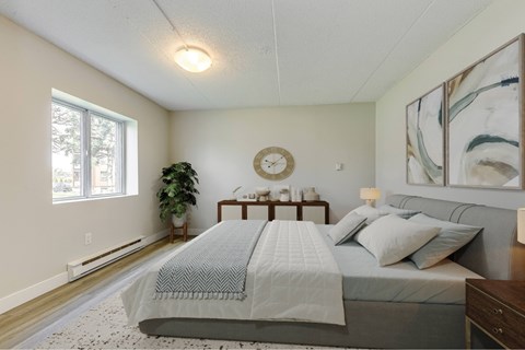 A bedroom with a large bed and a clock on the wall.