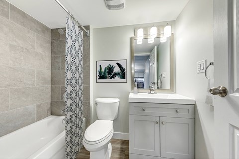 A bathroom with a white toilet, a white sink, and a white bathtub.