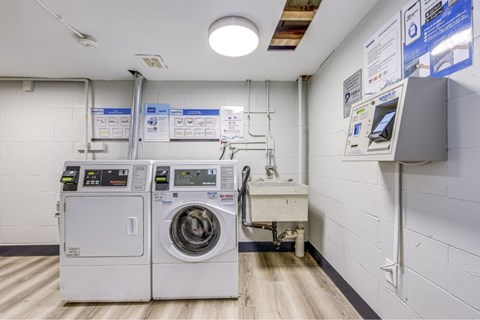 A laundry room with washers and dryers.