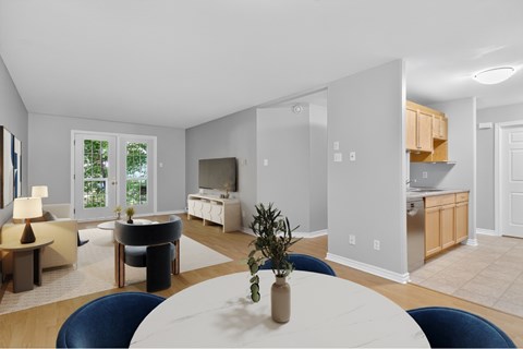 A modern dining room with a white table and blue chairs.