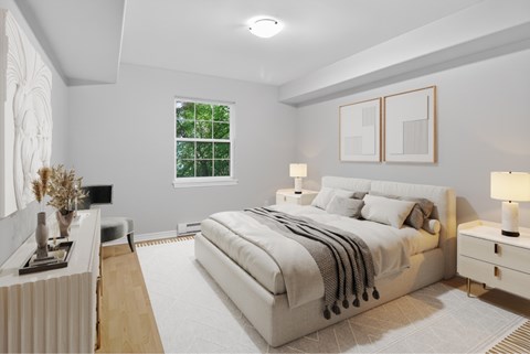 A bedroom with a large bed, a nightstand, and a window.