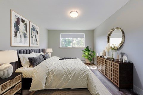 A bedroom with a large bed and a mirror on the wall.