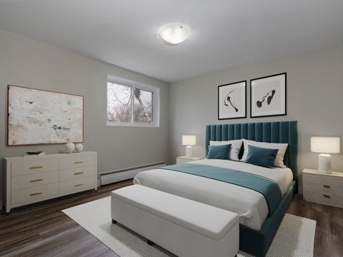 A bedroom with a large bed and a painting on the wall.