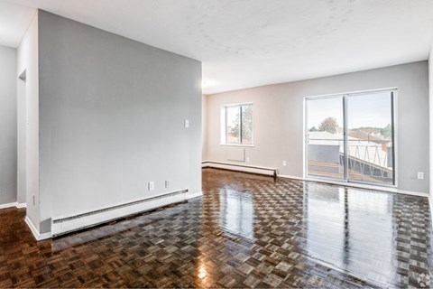 A room with a tiled floor and a sliding glass door.