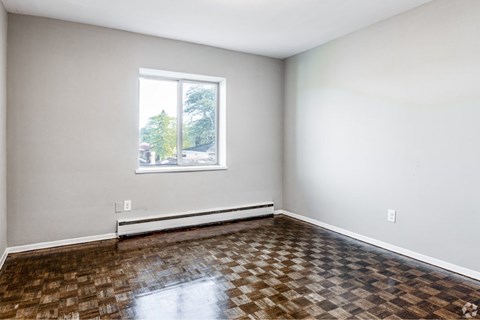 A room with a checkered floor and a window.