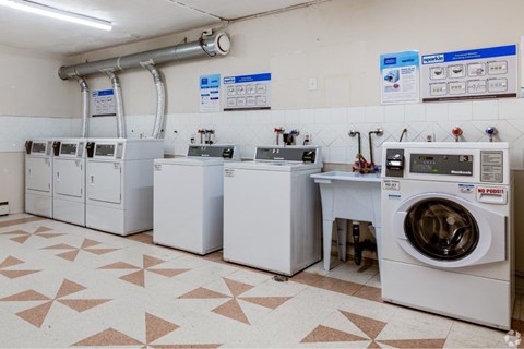 A laundry room with a washer and dryer on the right and a washing machine on the left.