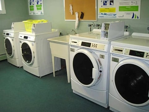 A row of washing machines in a laundromat.