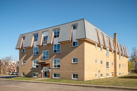 A modern building with a combination of brick and siding exterior.