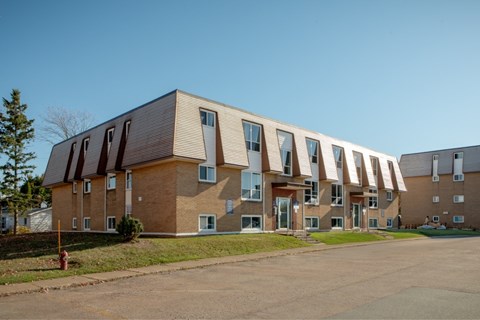 A long building with a lot of windows and doors.