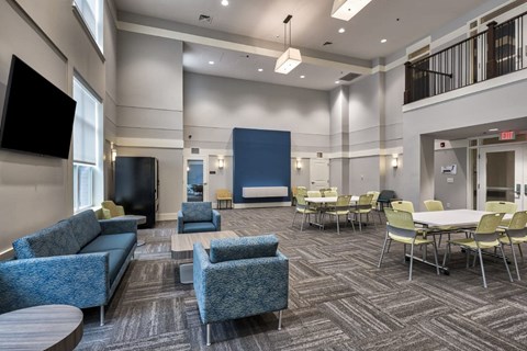 A conference room with a blue carpet and chairs.