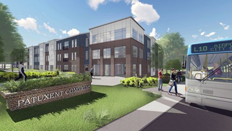 A bus is parked in front of a building with the sign "Patuxent Commons".