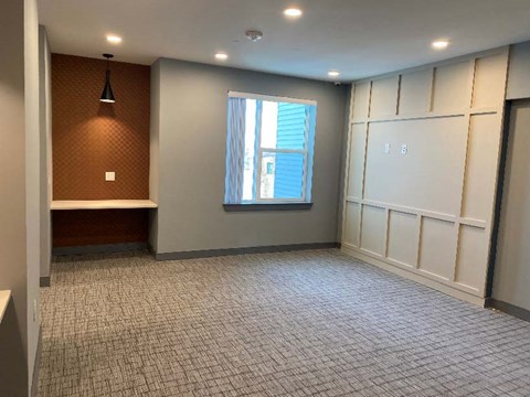 A room with a window and a tiled floor.