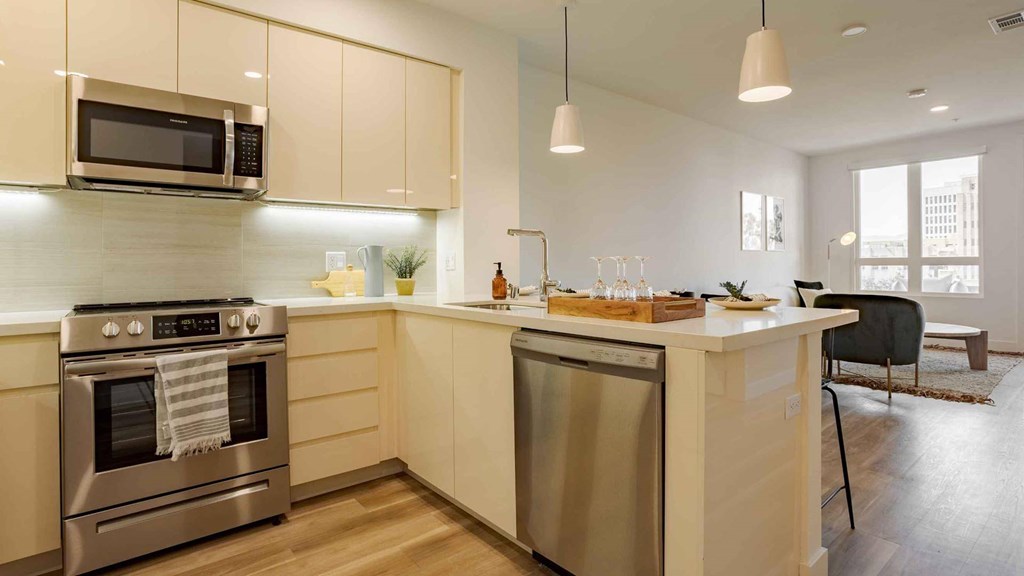 A modern kitchen with a stainless steel oven and microwave.