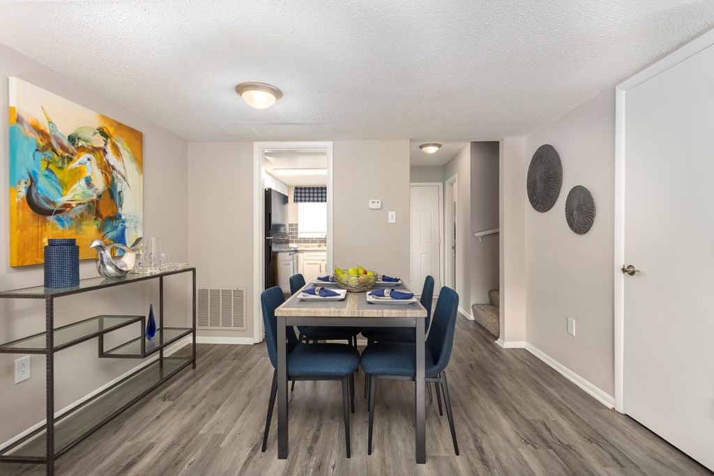 A dining room with a table set for four.