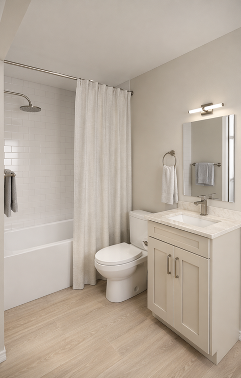 A white bathroom with a toilet, sink, and shower.
