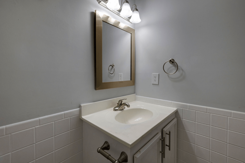 A bathroom sink with a mirror above it at Retreat at Savannah Apartments, Georgia
