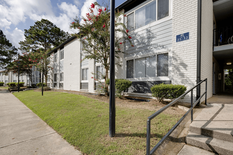 A white building with a blue sign on the front at Retreat at Savannah Apartments, Savannah, GA, 31404