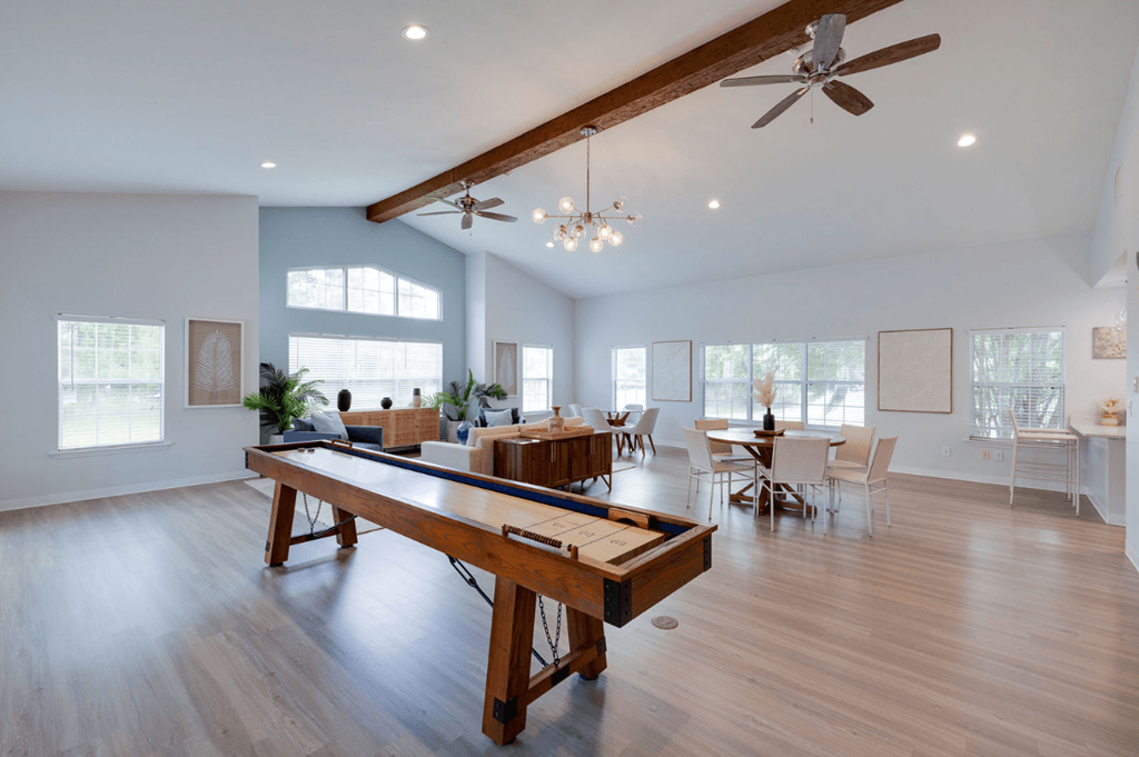A spacious room with a long wooden table and chairs at Retreat at Savannah Apartments, Savannah, GA, 31404