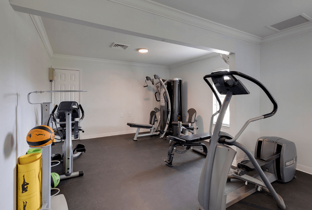 A well-equipped home gym with various exercise machines at Retreat at Savannah Apartments, Savannah