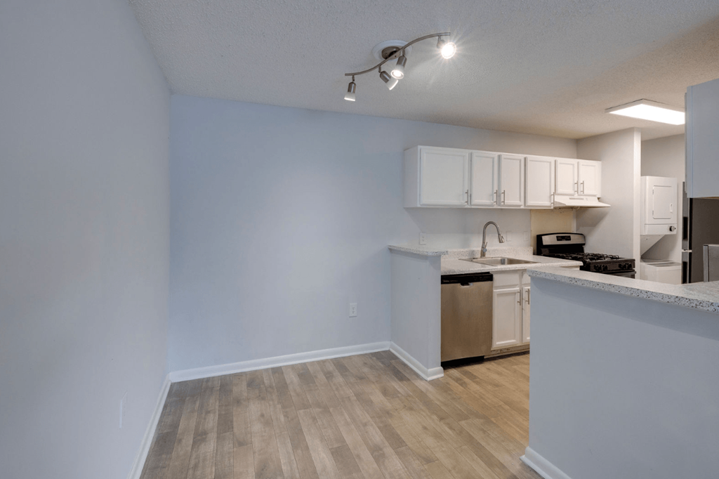 A kitchen area with a sink, stove, and cabinets at Retreat at Savannah Apartments, Georgia, 31404