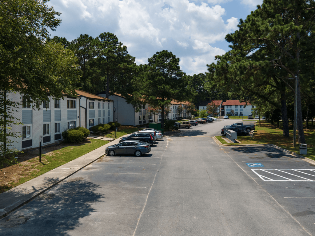 A street view of a residential area with cars parked on the side at Retreat at Savannah Apartments, Savannah, GA