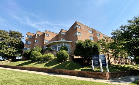 A large brick building with a sign in front that says "Bedford Place".