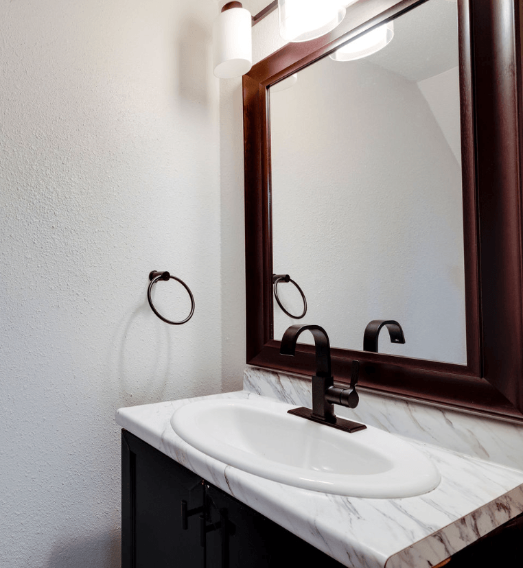 A white sink is under a mirror in a bathroom at Savan Pointe Apartments, Savannah, GA, 31406