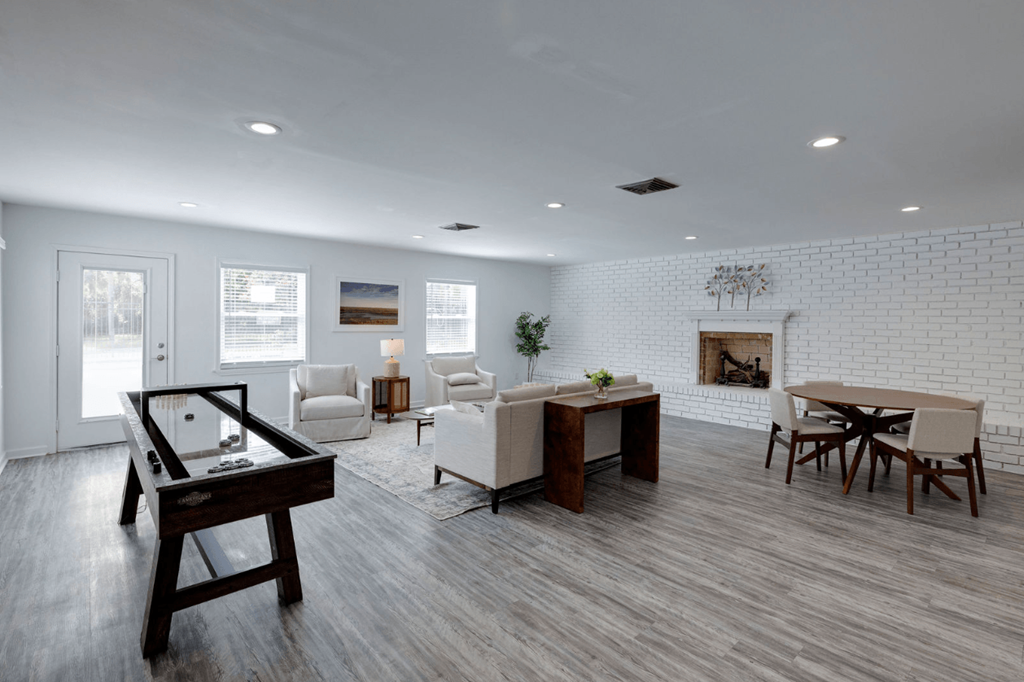 A modern living room with a pool table and a fireplace at Savan Pointe Apartments, Savannah
