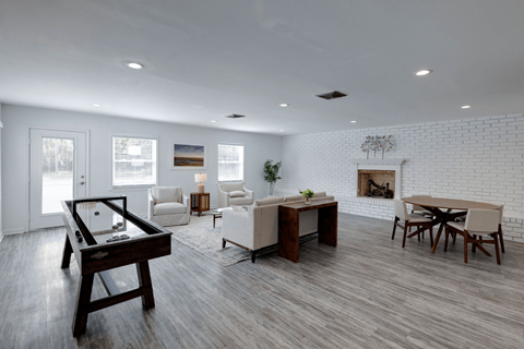 A modern living room with a pool table and a fireplace.