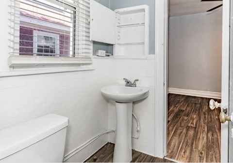 A white sink and toilet in a small bathroom.