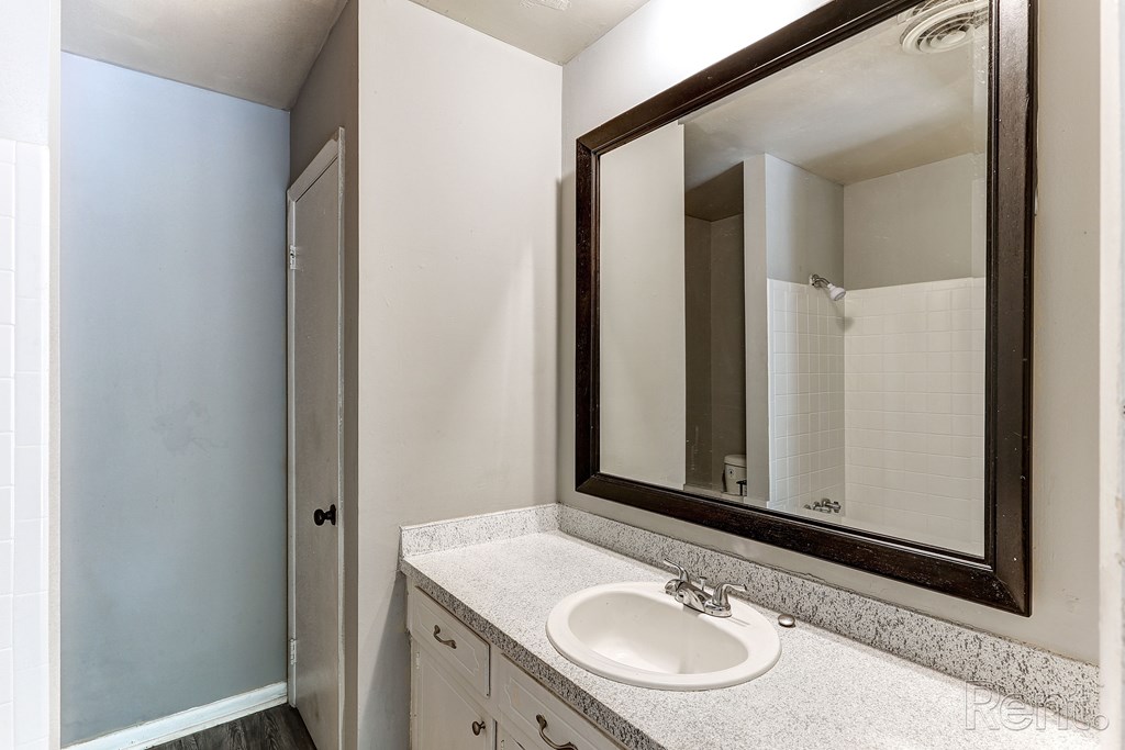 A bathroom with a sink and mirror.