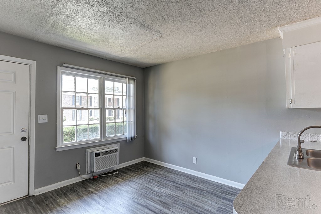 A room with a window and a sink.