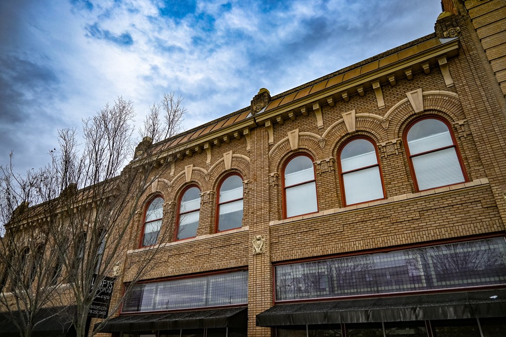 A building with arched windows and a brick facade.