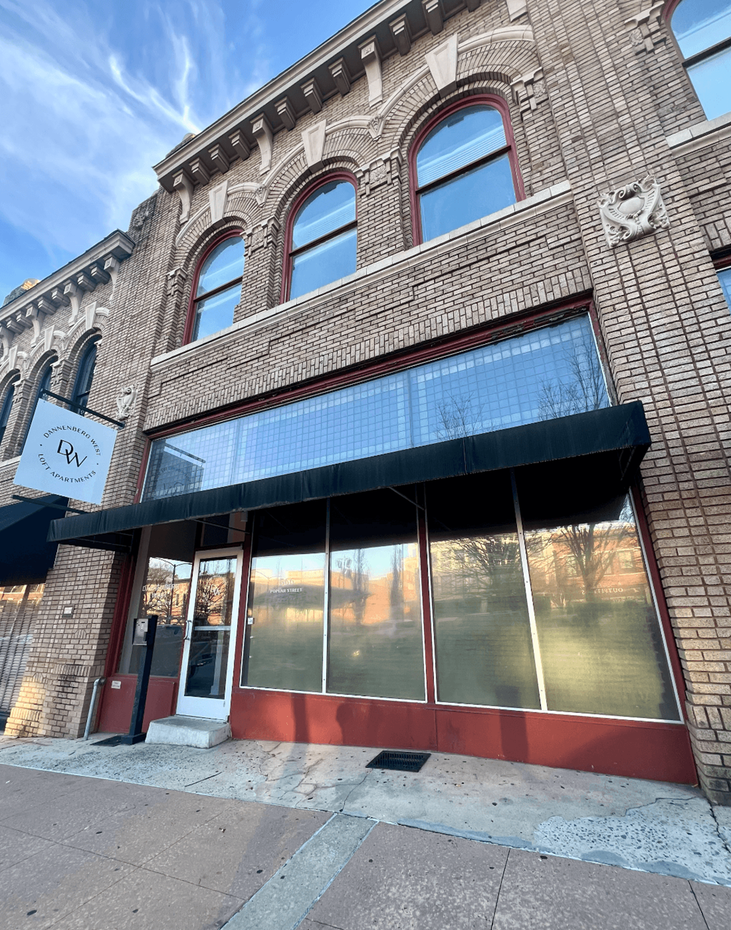 A building with a red door and windows.