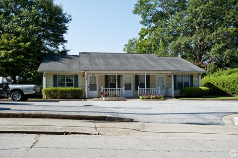 A house with a blue roof and white trim is shown.