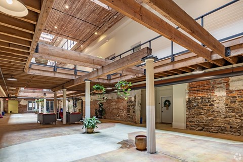 A large open space with a high ceiling and wooden beams.