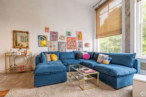 A living room with a blue couch and a coffee table.