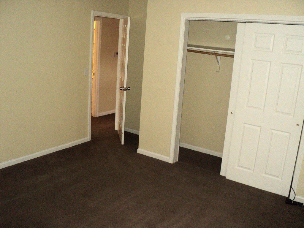 A room with a white door and a white closet door.