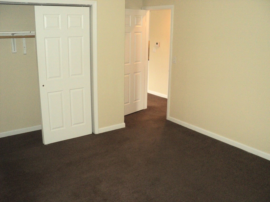 A white door is open to a hallway.