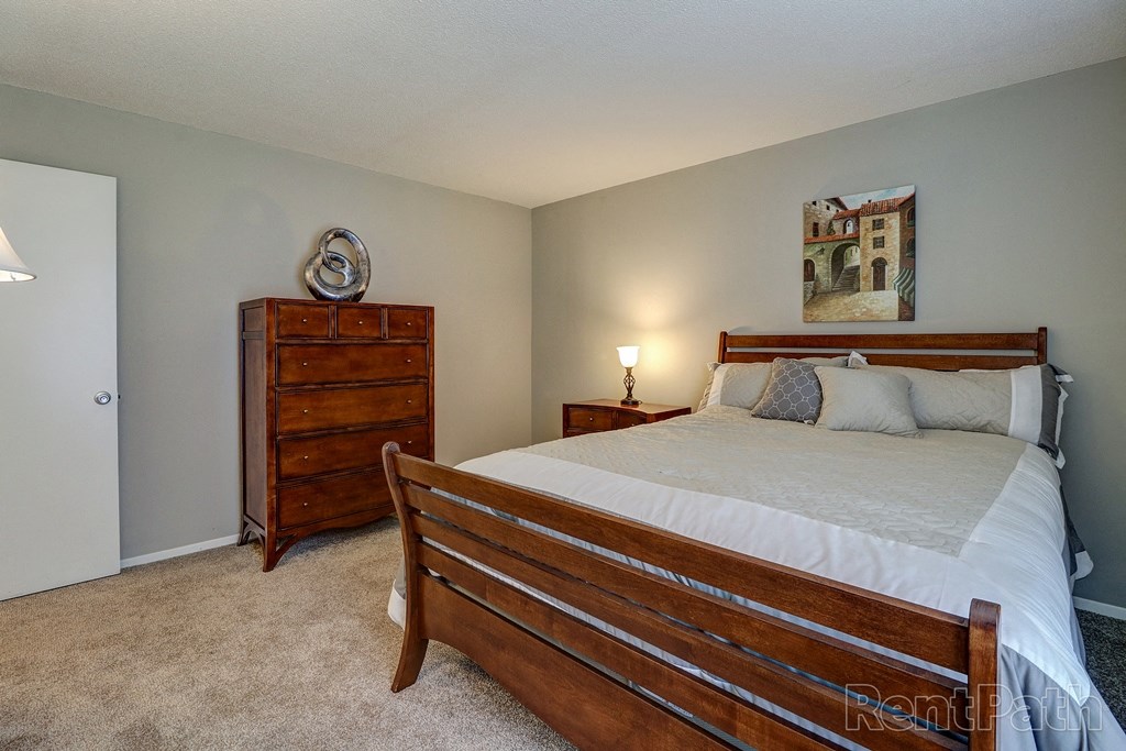 a bedroom with a bed and a dresser
