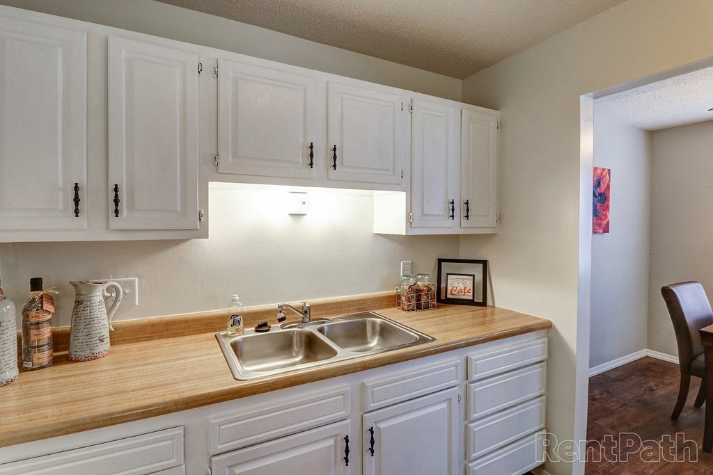 a kitchen with white cabinets and a sink