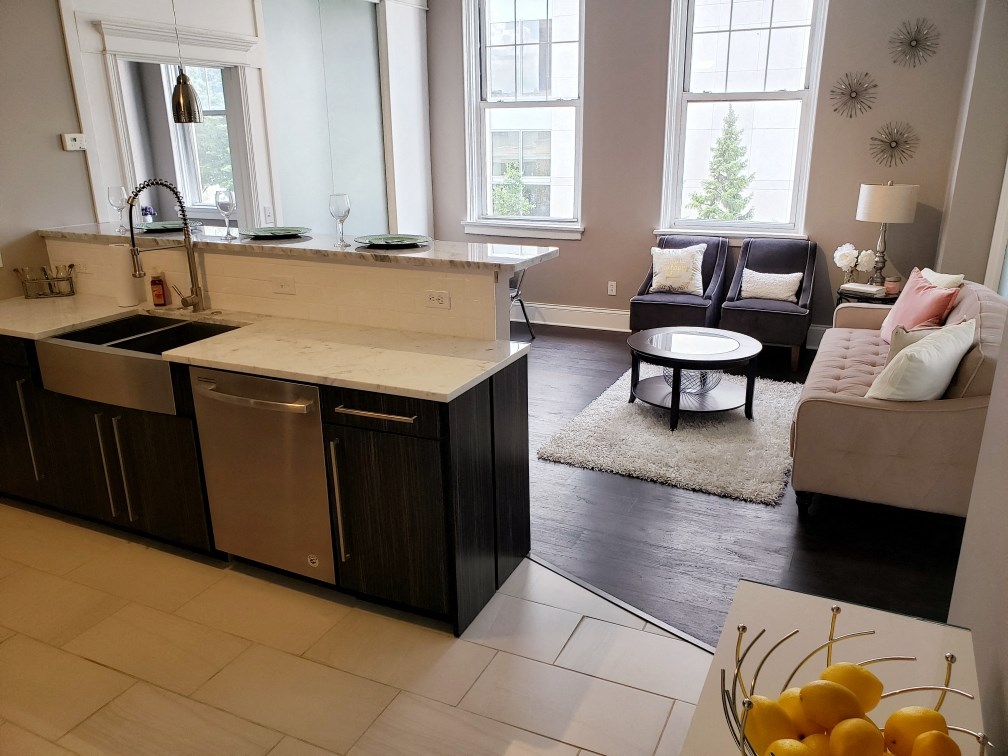 a view of a kitchen and living room with a couch and a table
