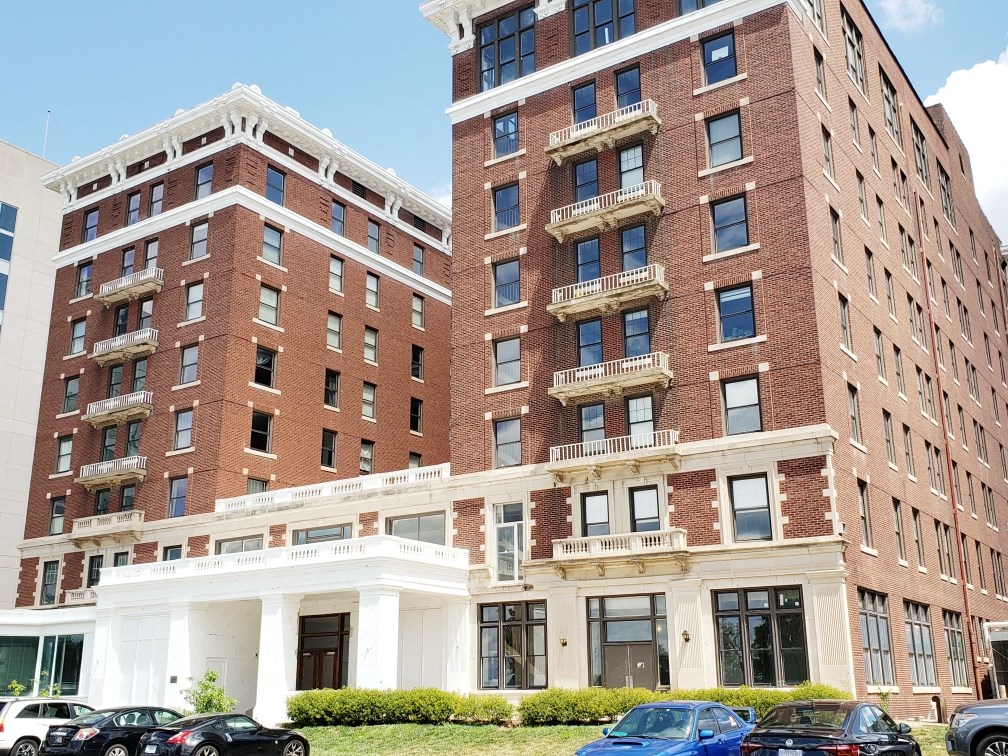 a large brick building with cars parked in front of it