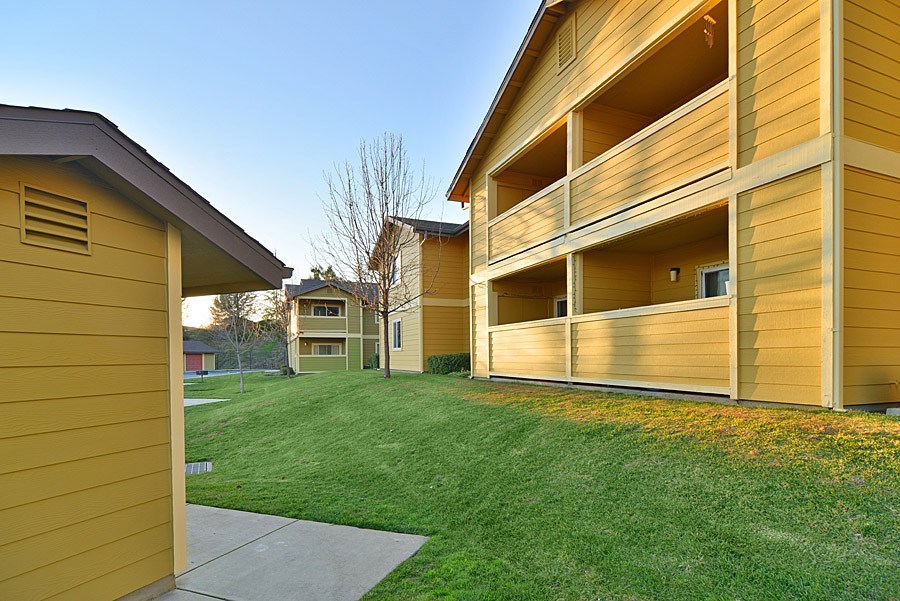 A yellow building with a balcony is in the foreground.