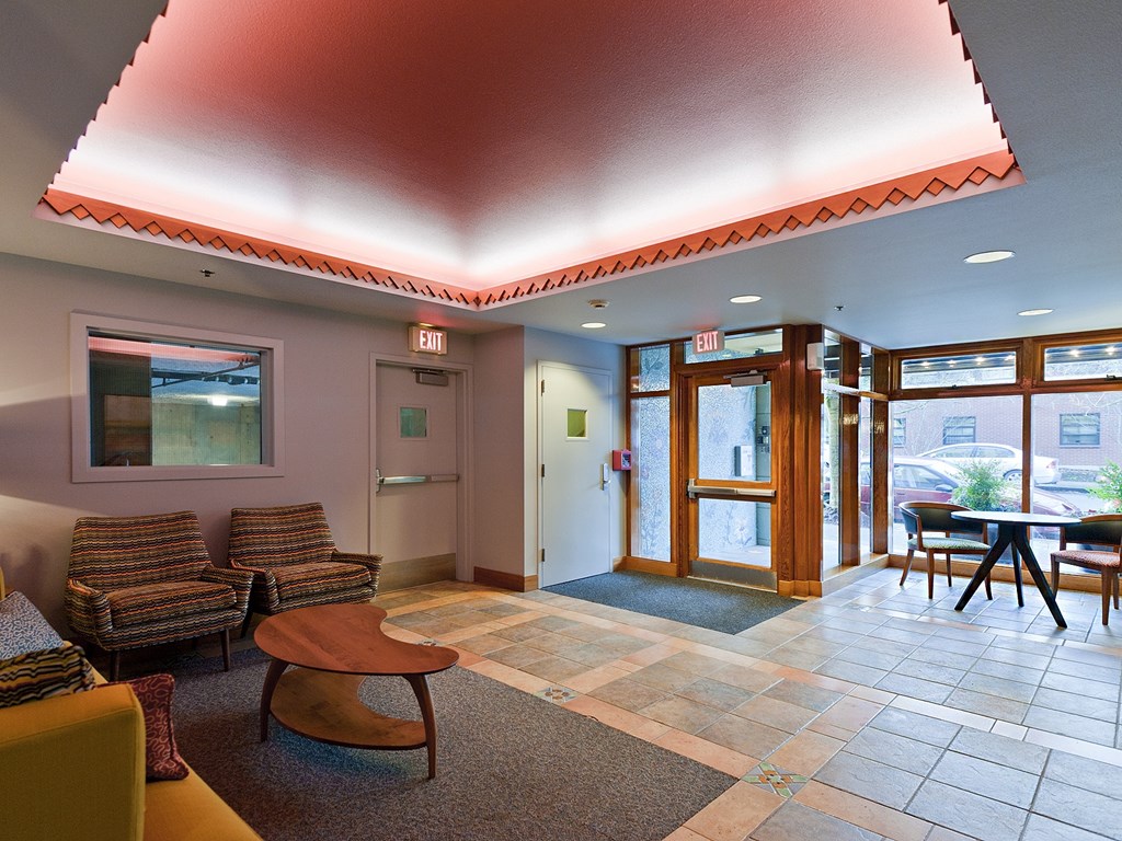 A waiting area with chairs and a table.