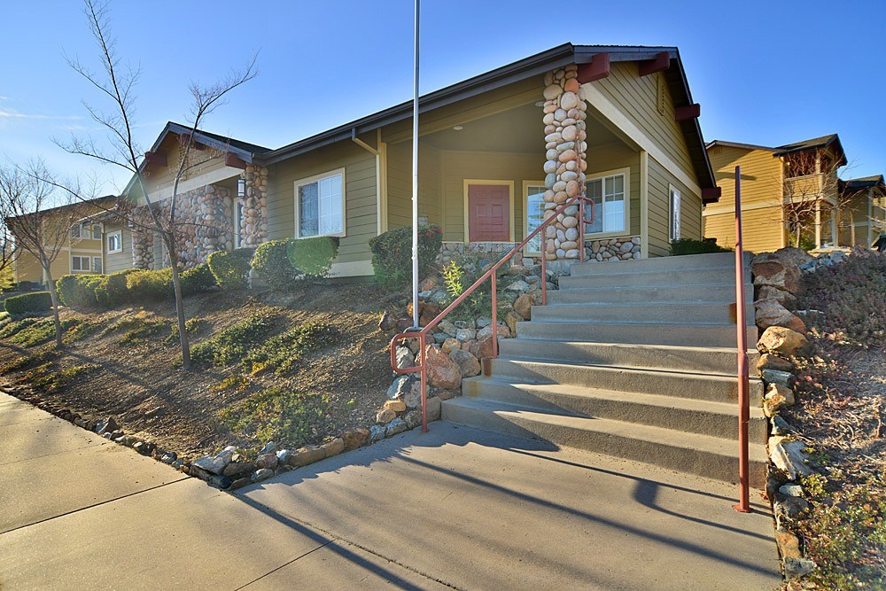 A house with a red door and a stone pillar.