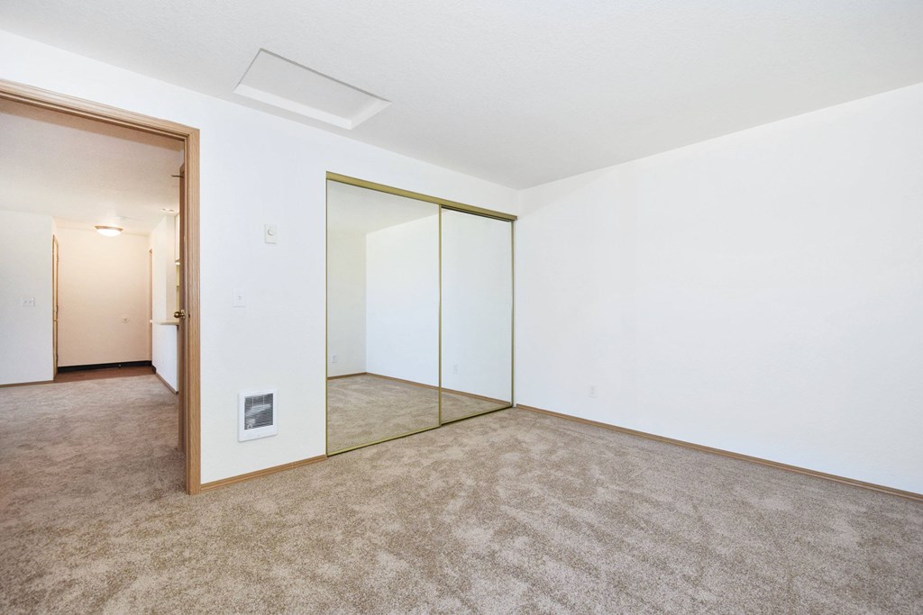 A room with a carpeted floor and a glass partition wall.