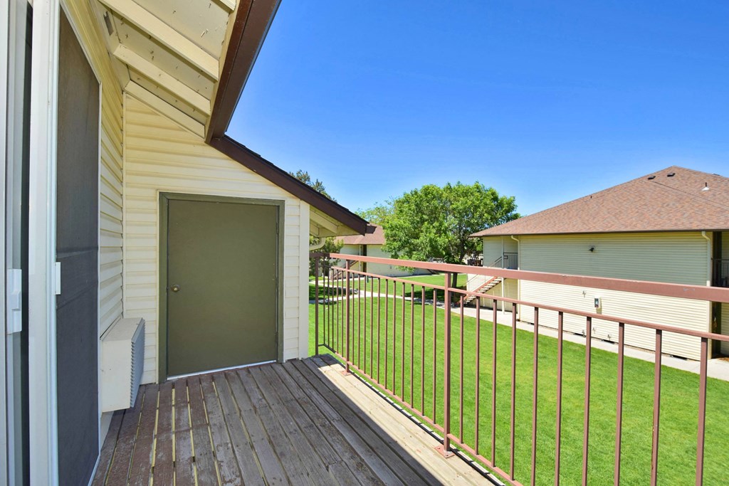A house with a green door and a brown fence.