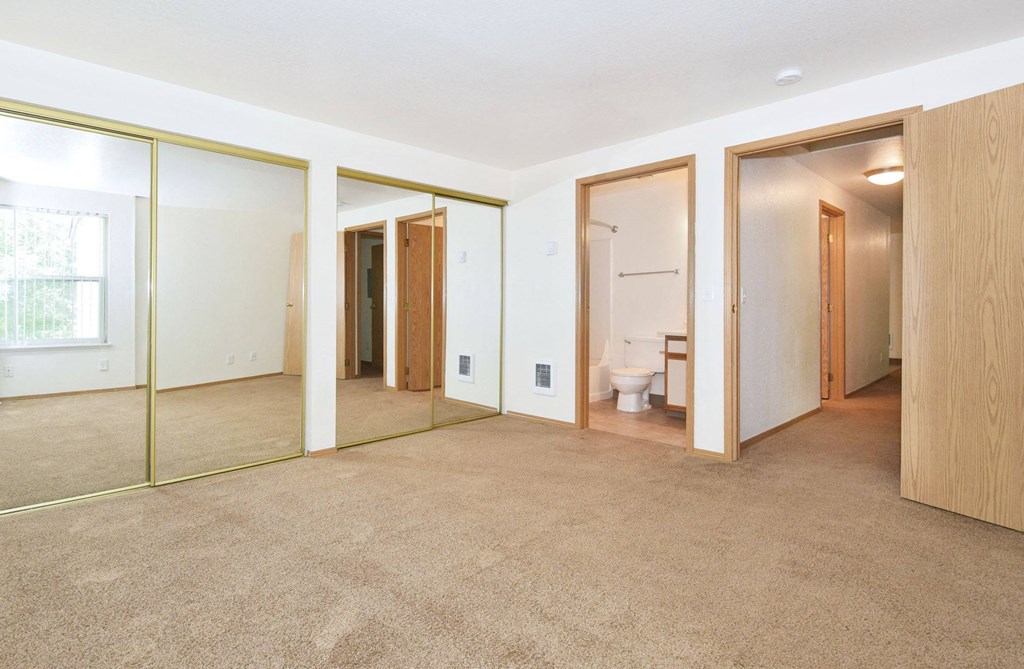 A room with a carpeted floor and a glass door.