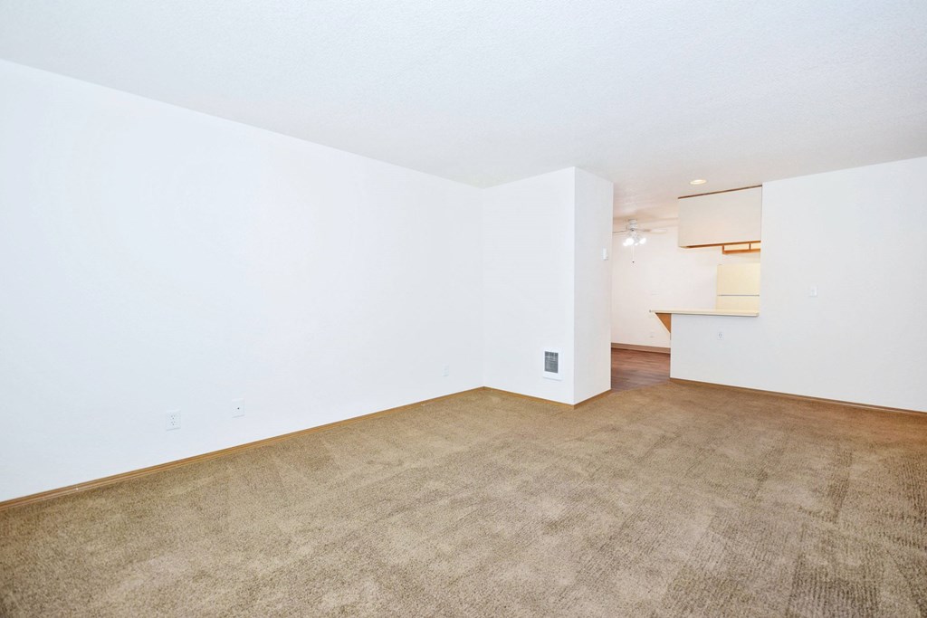 A room with a carpeted floor and white walls.
